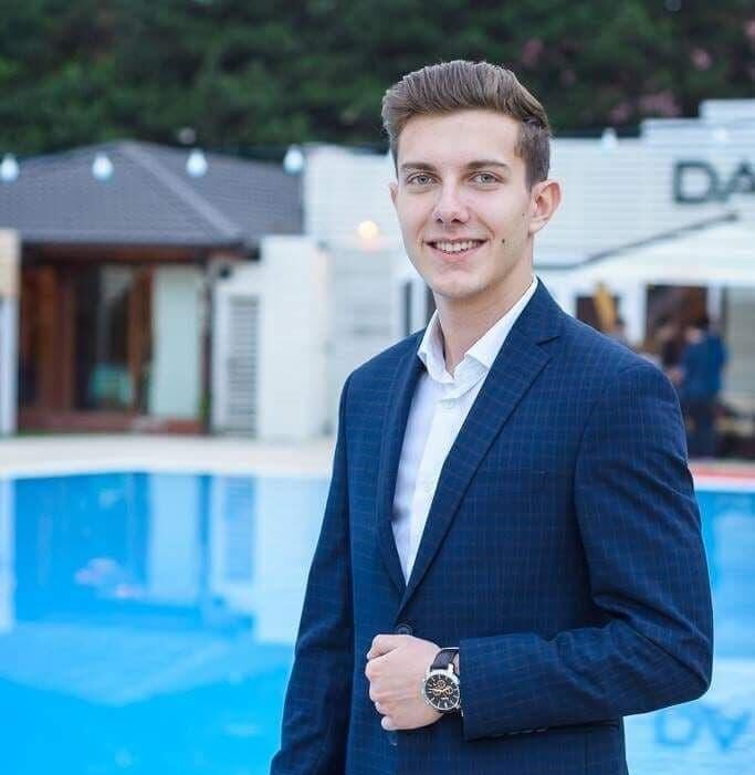 The CFO is dressed in a professional suit and is engaged in the conversation with the other participants.